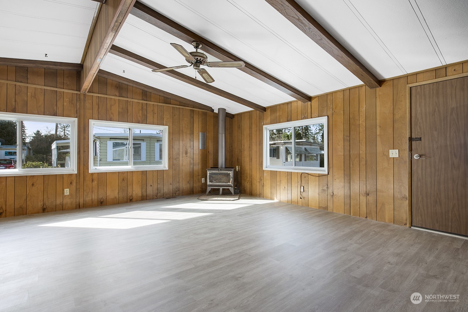 2302 R Street Southeast, Unit 140 Auburn, WA 98002 - Photo 3 of 18 an empty room with wooden floor and windows