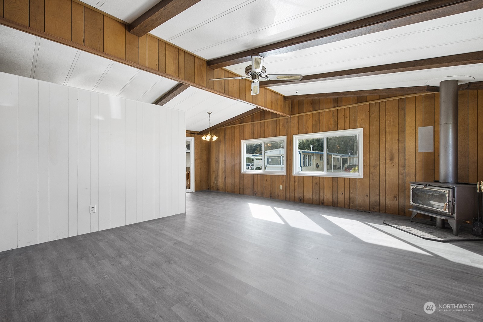 2302 R Street Southeast, Unit 140 Auburn, WA 98002 - Photo 4 of 18 an empty room with wooden floor and windows