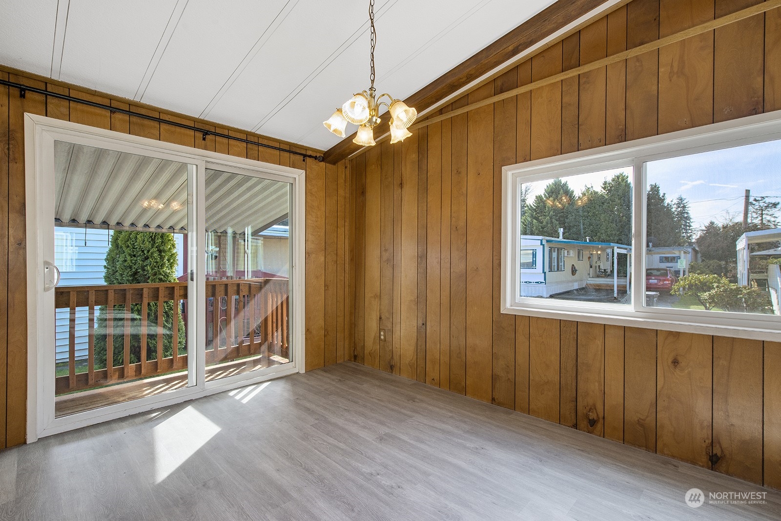 2302 R Street Southeast, Unit 140 Auburn, WA 98002 - Photo 7 of 18 a view of a room with a large window wooden floor and deck