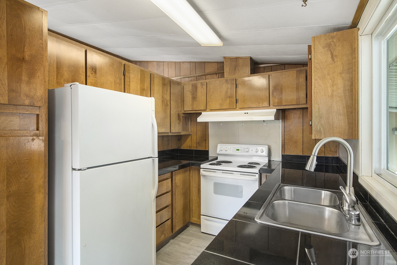 2302 R Street Southeast, Unit 140 Auburn, WA 98002 - Photo 9 of 18 a kitchen with a refrigerator sink stove and cabinets