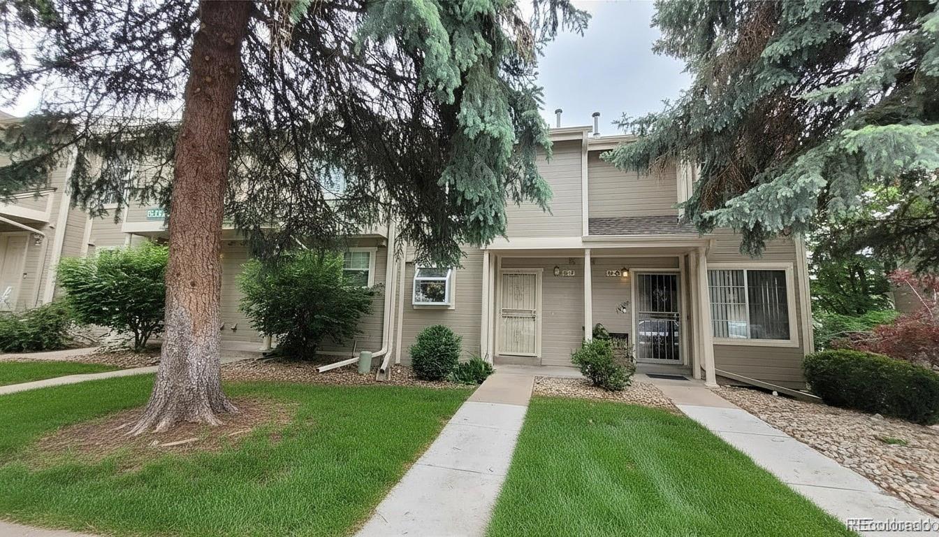 a front view of a house with a garden and yard