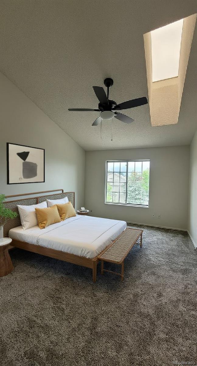 1818 South Quebec Way, Unit 57 Denver, CO 80231 - Photo 16 of 28 a bed room with a bed and a large window