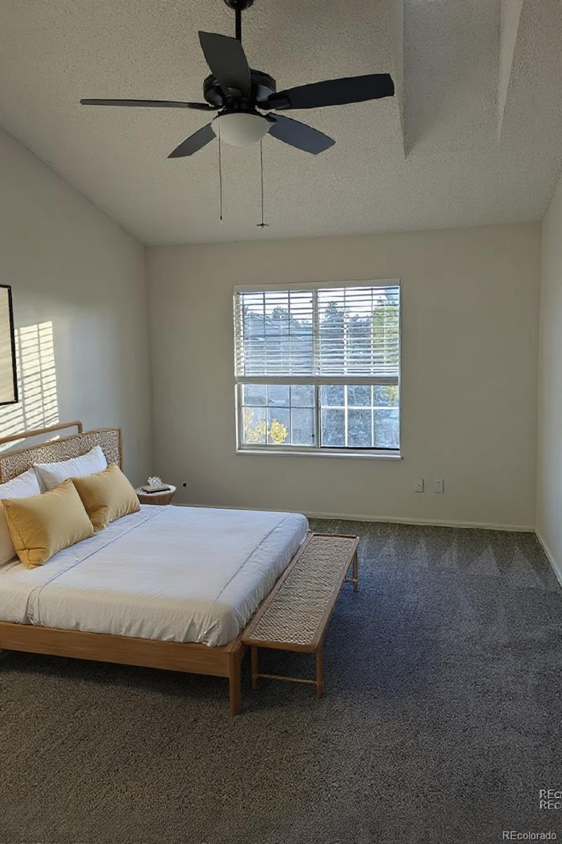 1818 South Quebec Way, Unit 57 Denver, CO 80231 - Photo 17 of 28 a bedroom with a bed and a window