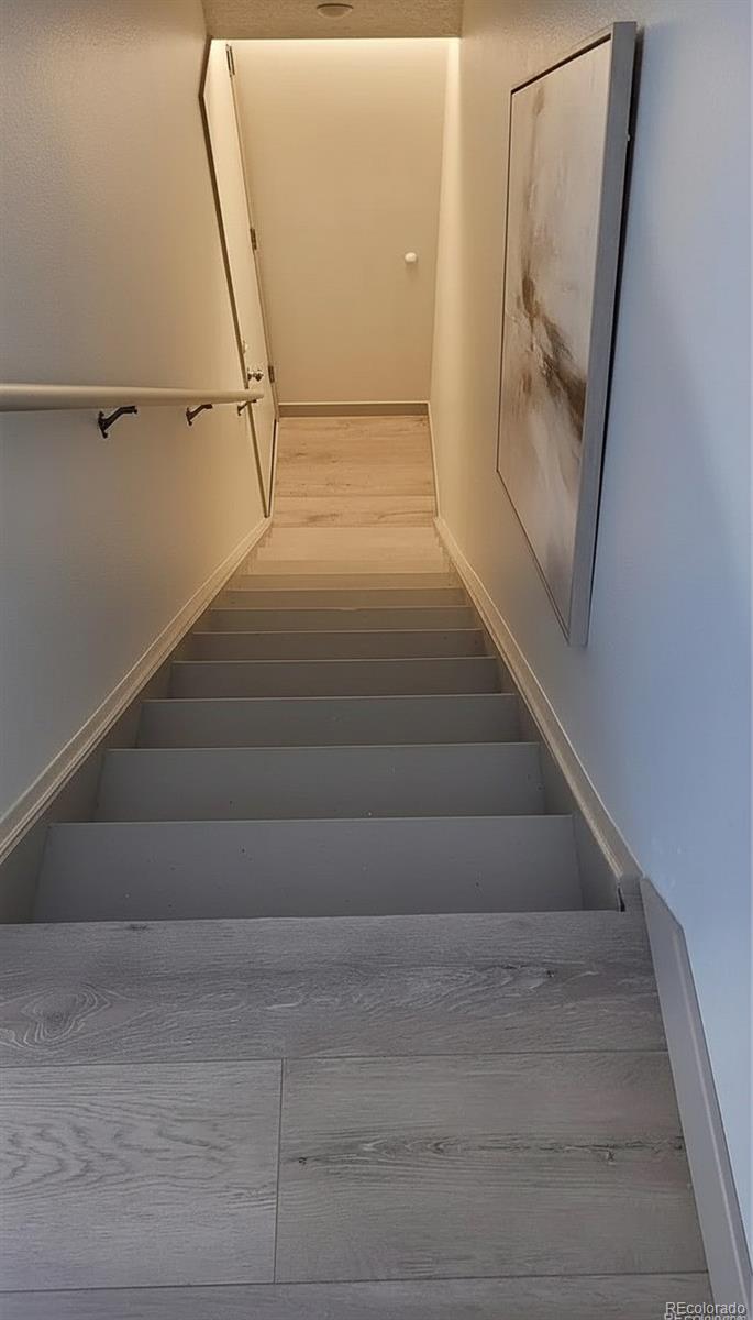1818 South Quebec Way, Unit 57 Denver, CO 80231 - Photo 20 of 28 a view of staircase with white walls and railing