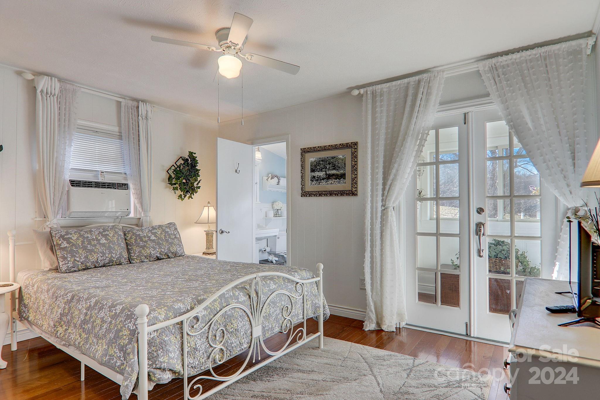 36 Brookside Lane Maggie Valley, NC 28751 - Photo 21 of 48 a bedroom with a large bed and a chandelier