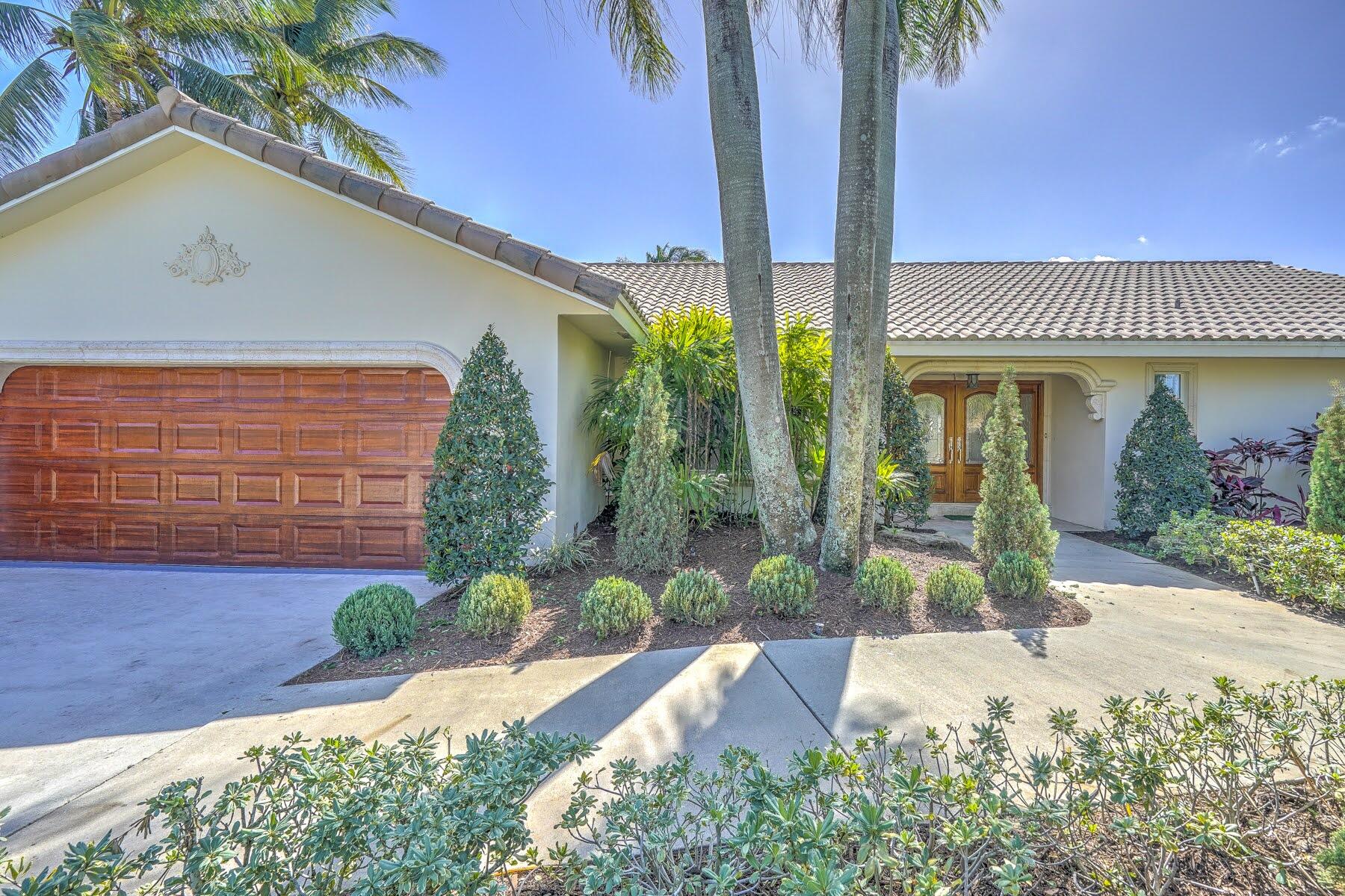 752 Southwest 36th Avenue Delray Beach, FL 33445 - Photo 3 of 40 a front view of a house with garden