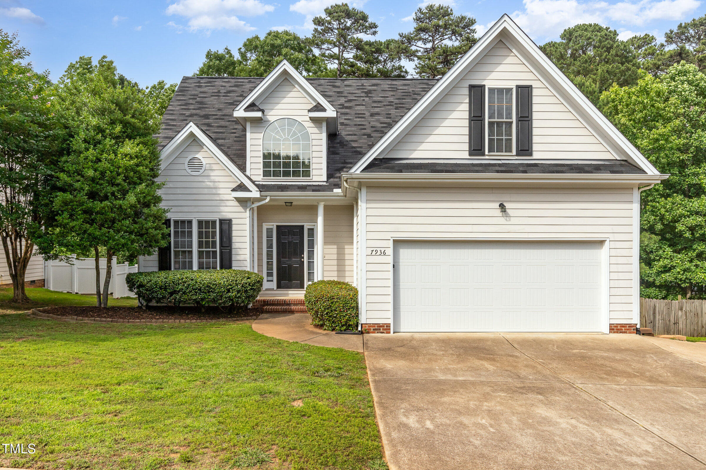 7936 Milltrace Run Raleigh, NC 27615 - Photo 1 of 21 a front view of a house with a garden and plants