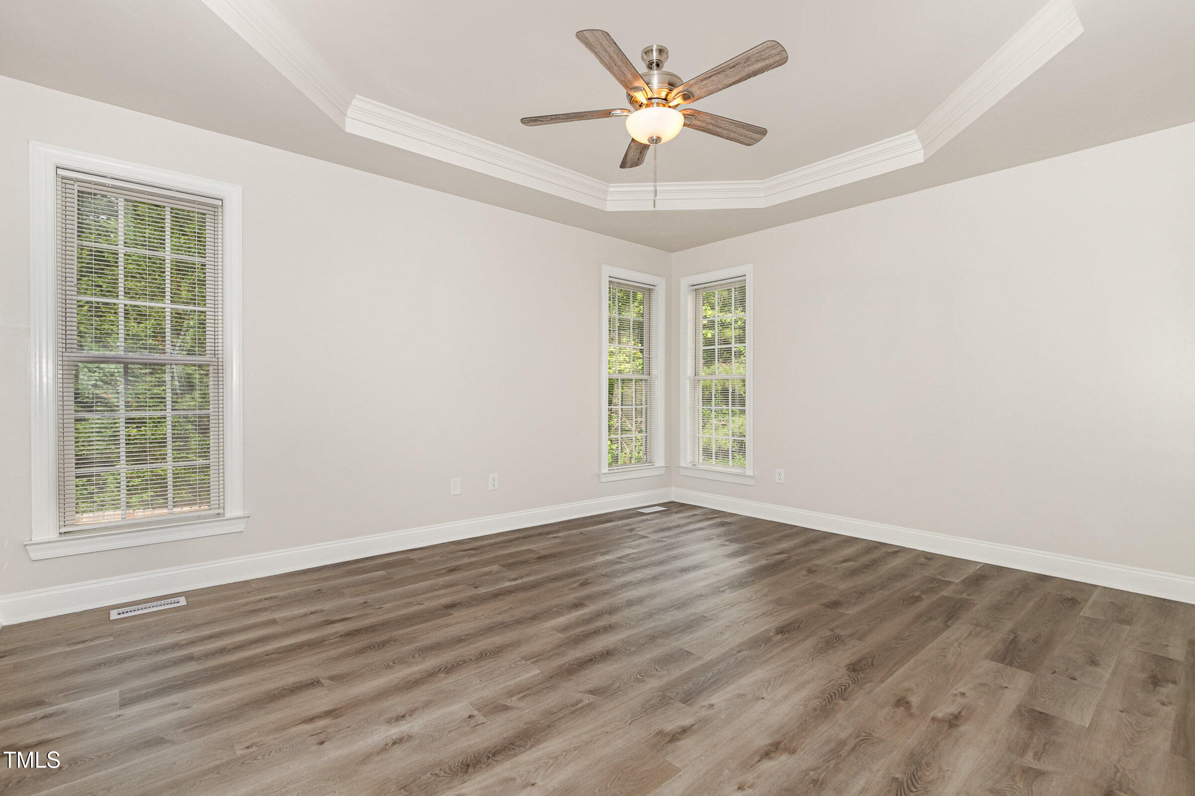 7936 Milltrace Run Raleigh, NC 27615 - Photo 10 of 21 a view of an empty room with a window and wooden floor