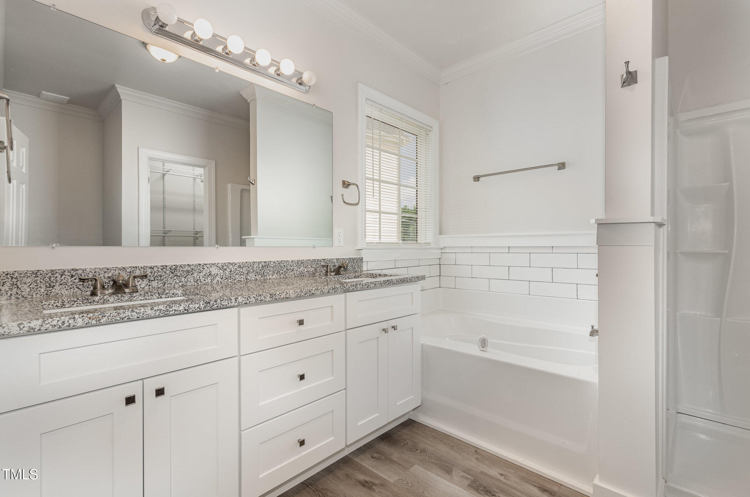 7936 Milltrace Run Raleigh, NC 27615 - Photo 12 of 21 a bathroom with a granite countertop sink mirror and bathtub
