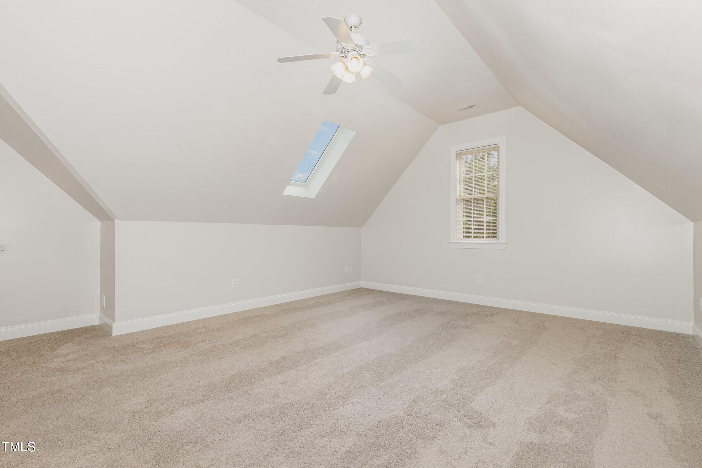 7936 Milltrace Run Raleigh, NC 27615 - Photo 16 of 21 an empty room with windows and fan