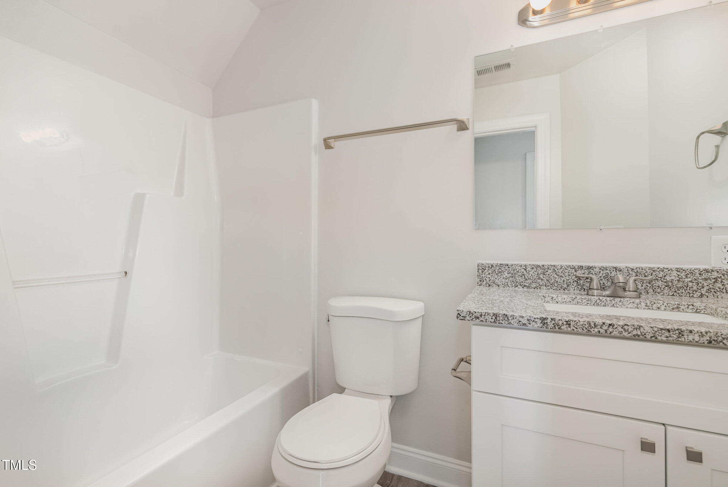 7936 Milltrace Run Raleigh, NC 27615 - Photo 17 of 21 a bathroom with a granite countertop toilet a sink and a bathtub