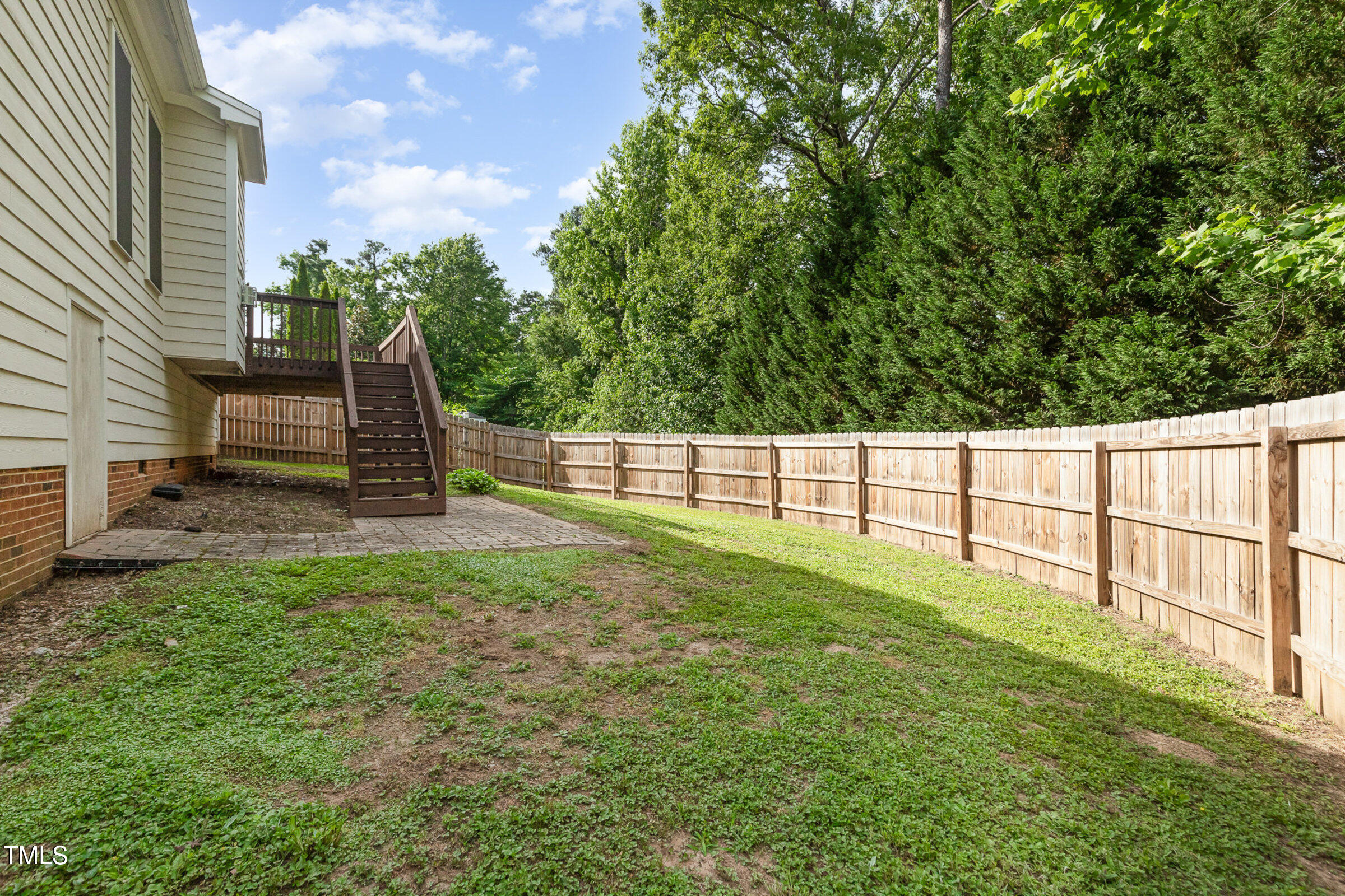 7936 Milltrace Run Raleigh, NC 27615 - Photo 19 of 21 a view of a backyard with grass and wooden fence
