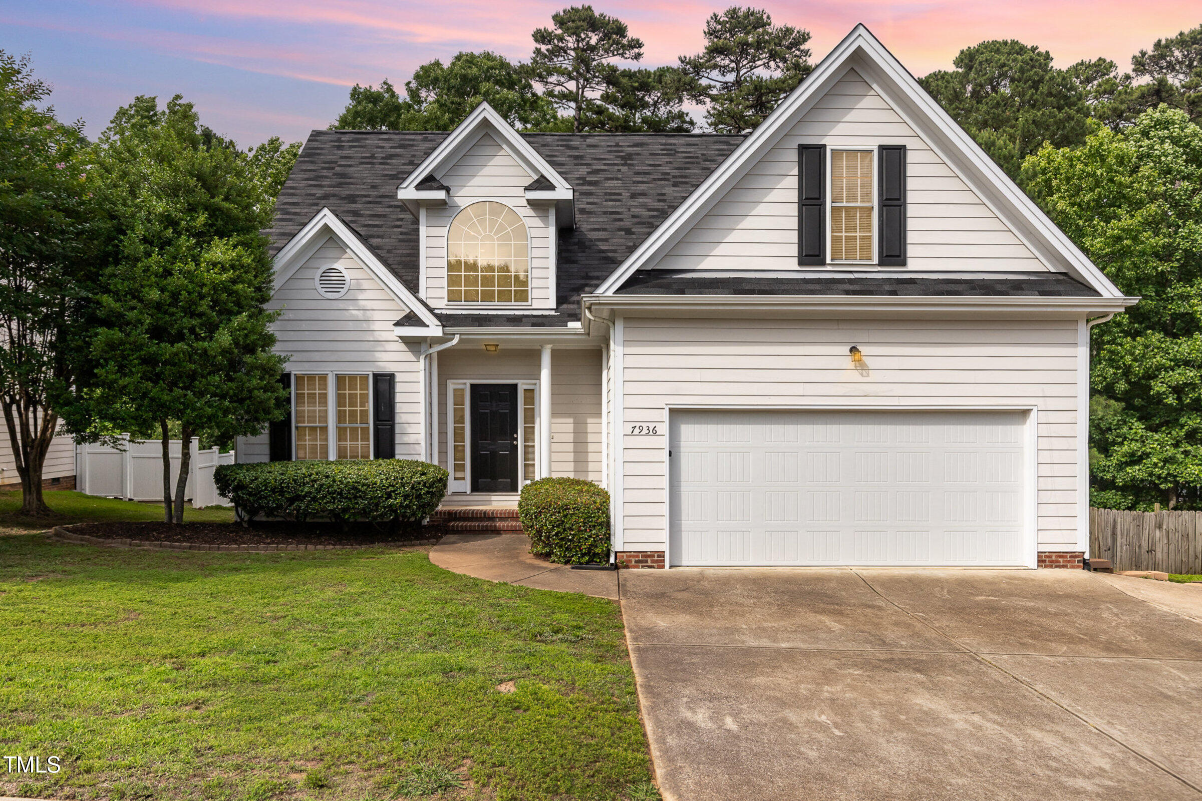 7936 Milltrace Run Raleigh, NC 27615 - Photo 20 of 21 a front view of a house with a garden and plants