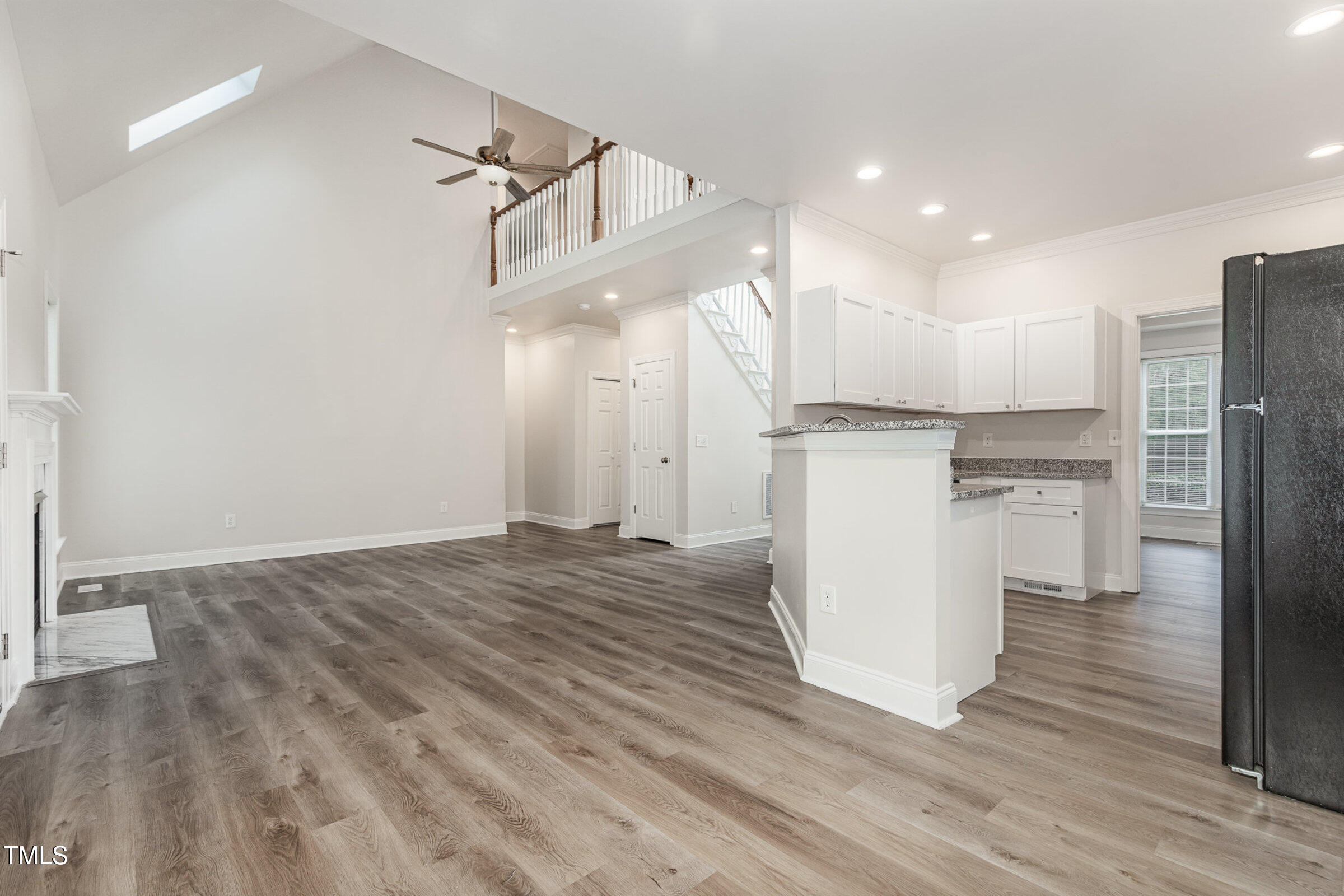 7936 Milltrace Run Raleigh, NC 27615 - Photo 5 of 21 a view of a kitchen with refrigerator and wooden floor