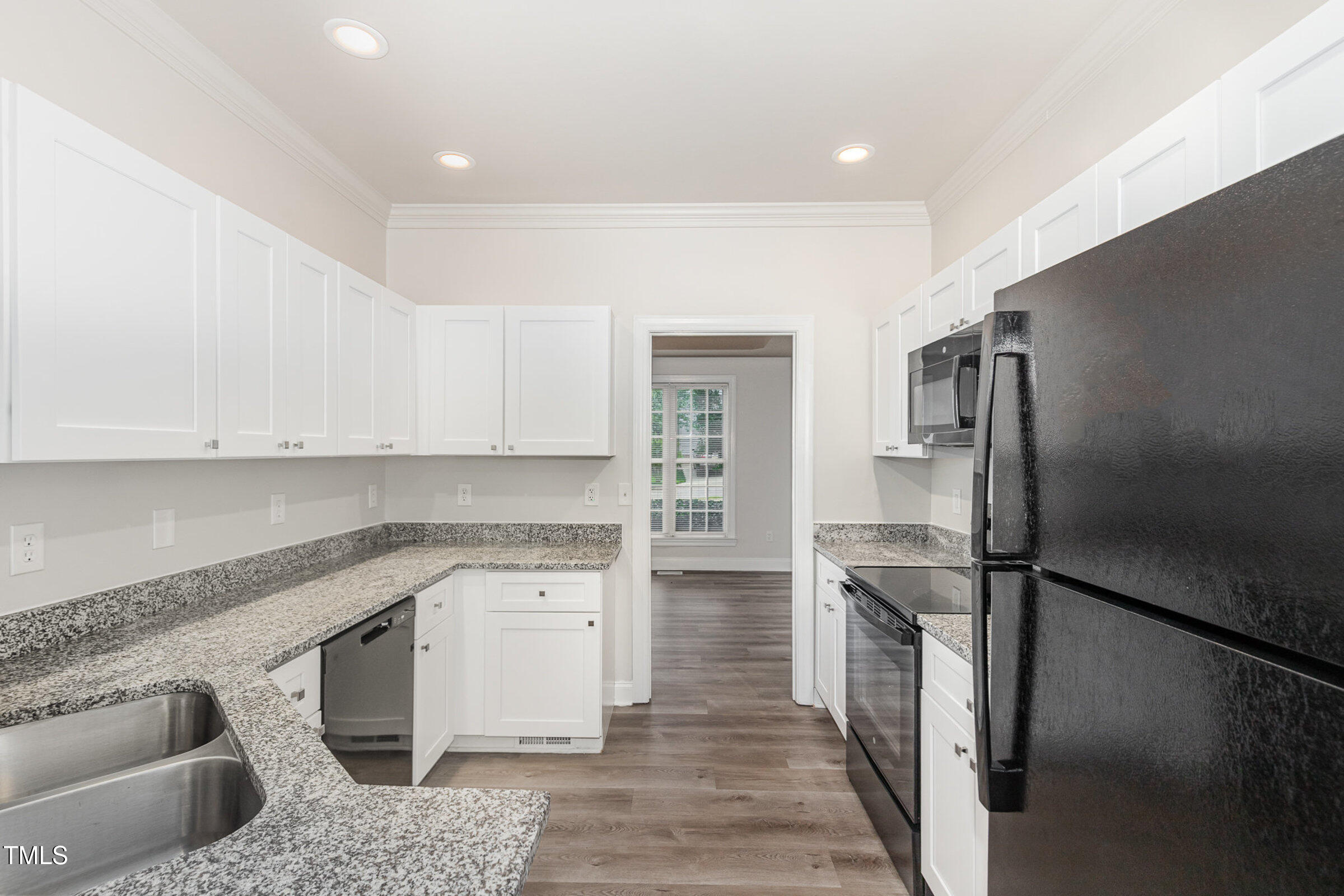 7936 Milltrace Run Raleigh, NC 27615 - Photo 6 of 21 a kitchen with a sink stove and refrigerator