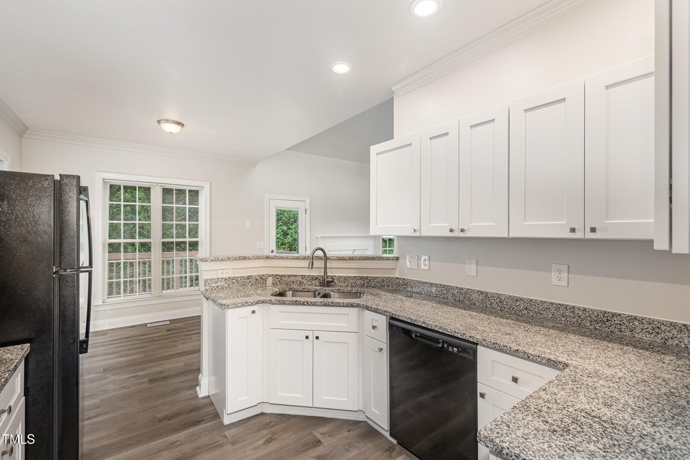 7936 Milltrace Run Raleigh, NC 27615 - Photo 7 of 21 a kitchen with a sink stove and cabinets