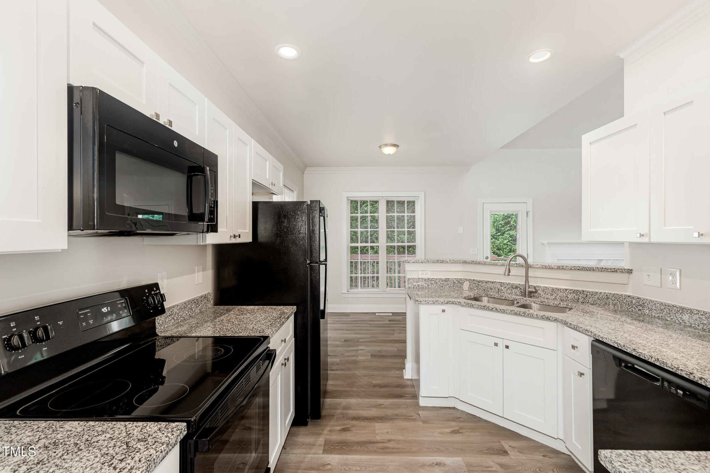 7936 Milltrace Run Raleigh, NC 27615 - Photo 8 of 21 a kitchen with a sink stove and microwave