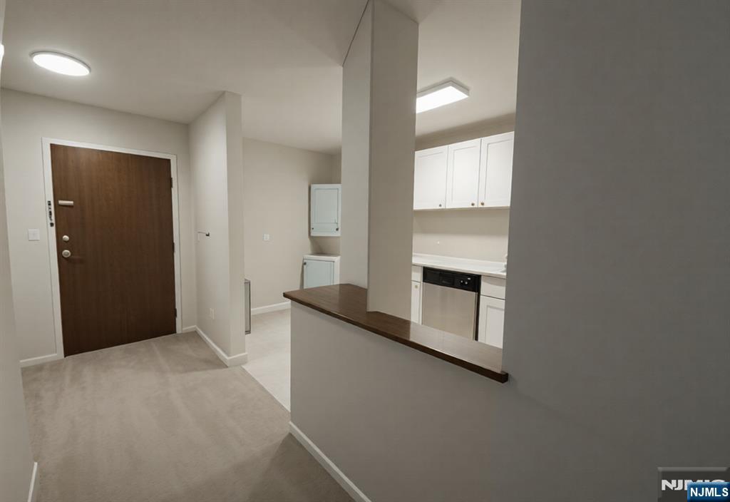 50 Euclid Avenue, Unit 3B Hackensack, NJ 07601 - Photo 7 of 16 a view of a kitchen with an empty room and wooden floor