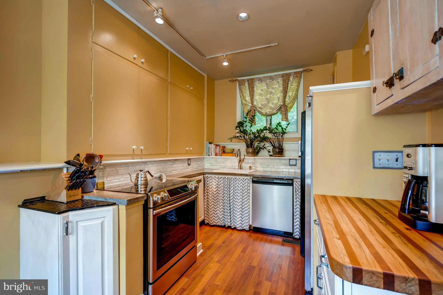 5106 North Franklintown Road Baltimore, MD 21207 - Photo 6 of 22 a kitchen with stainless steel appliances a sink a stove and wooden floor