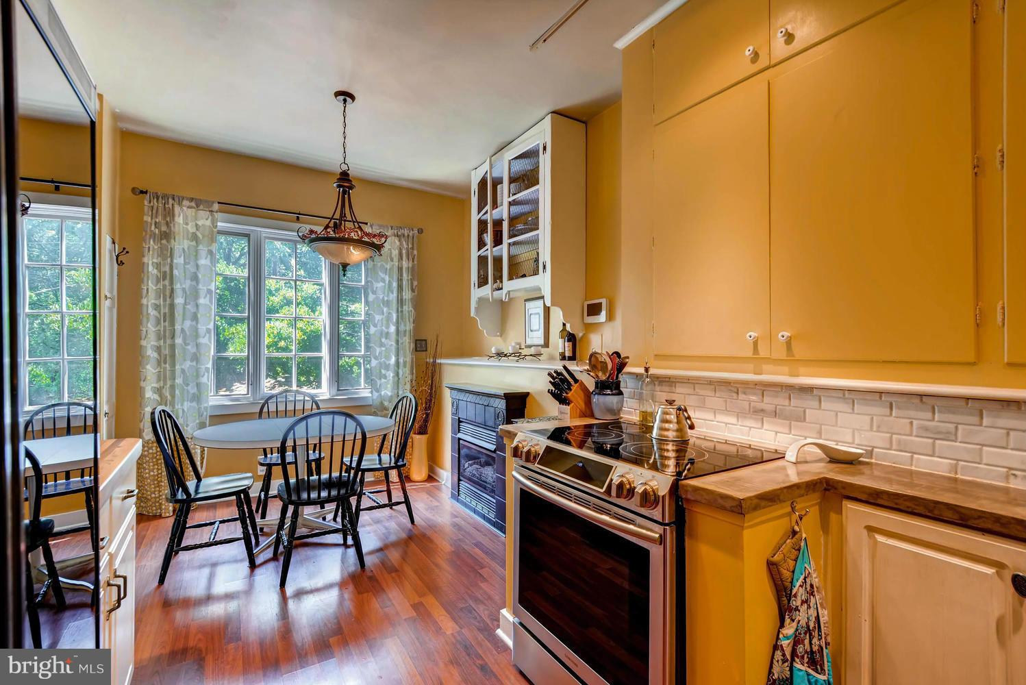 5106 North Franklintown Road Baltimore, MD 21207 - Photo 8 of 22 a view of a dining room with furniture window and wooden floor