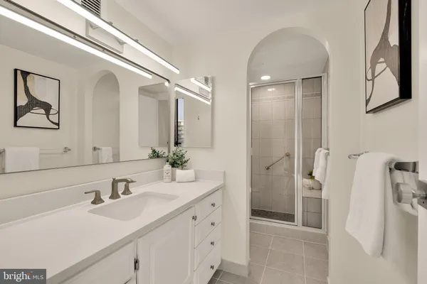 a bathroom with a double vanity sink mirror and shower