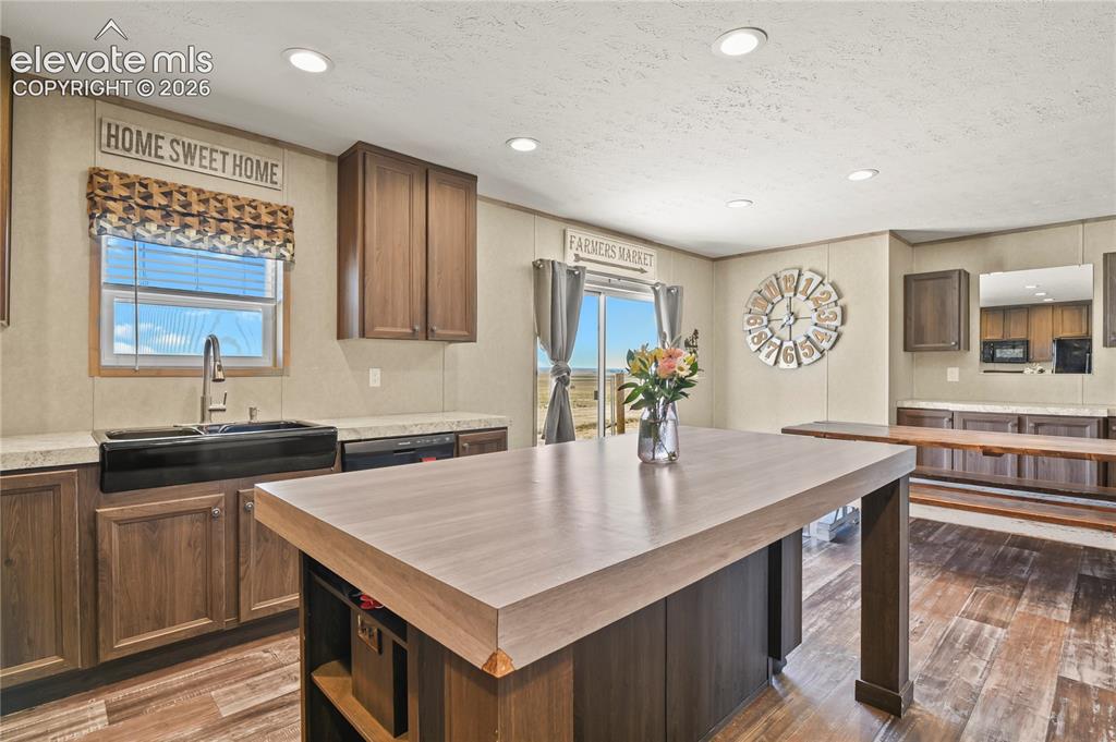 22280 Jones Road Peyton, CO 80831 - Photo 14 of 47 a kitchen with granite countertop a sink a counter top space and cabinets