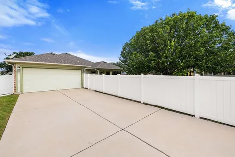 an aerial view of a house with swimming pool and furniture