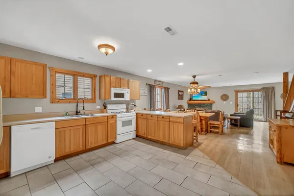 a large white kitchen with a large window