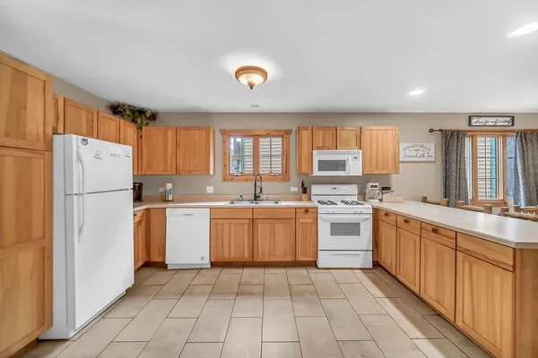 a kitchen with a refrigerator and a sink