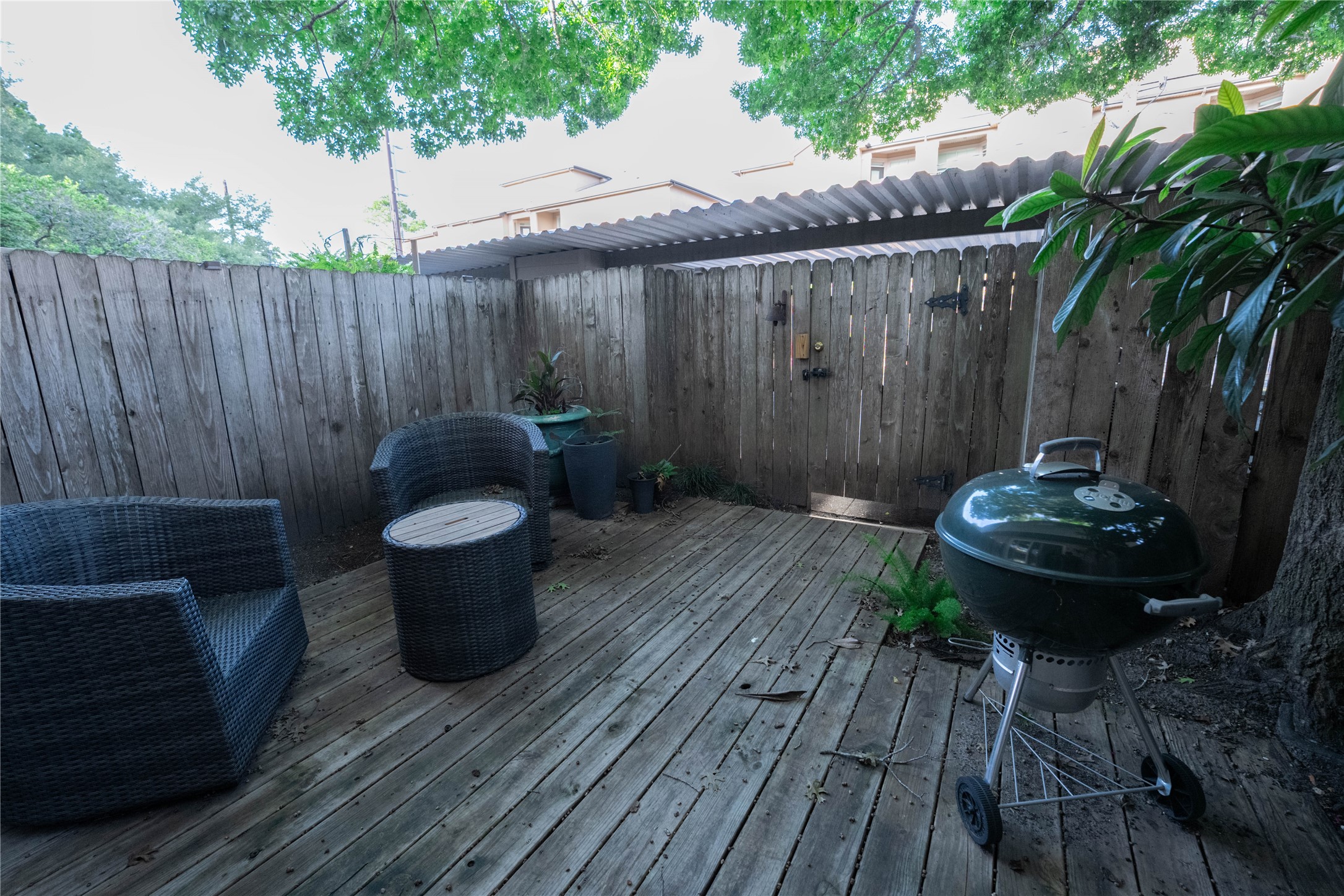 7447 Brompton Street, Unit 7447 Houston, TX 77025 - Photo 24 of 27 Inviting backyard patio offering the ideal space for outdoor entertaining and peaceful mornings with a cup of coffee.
