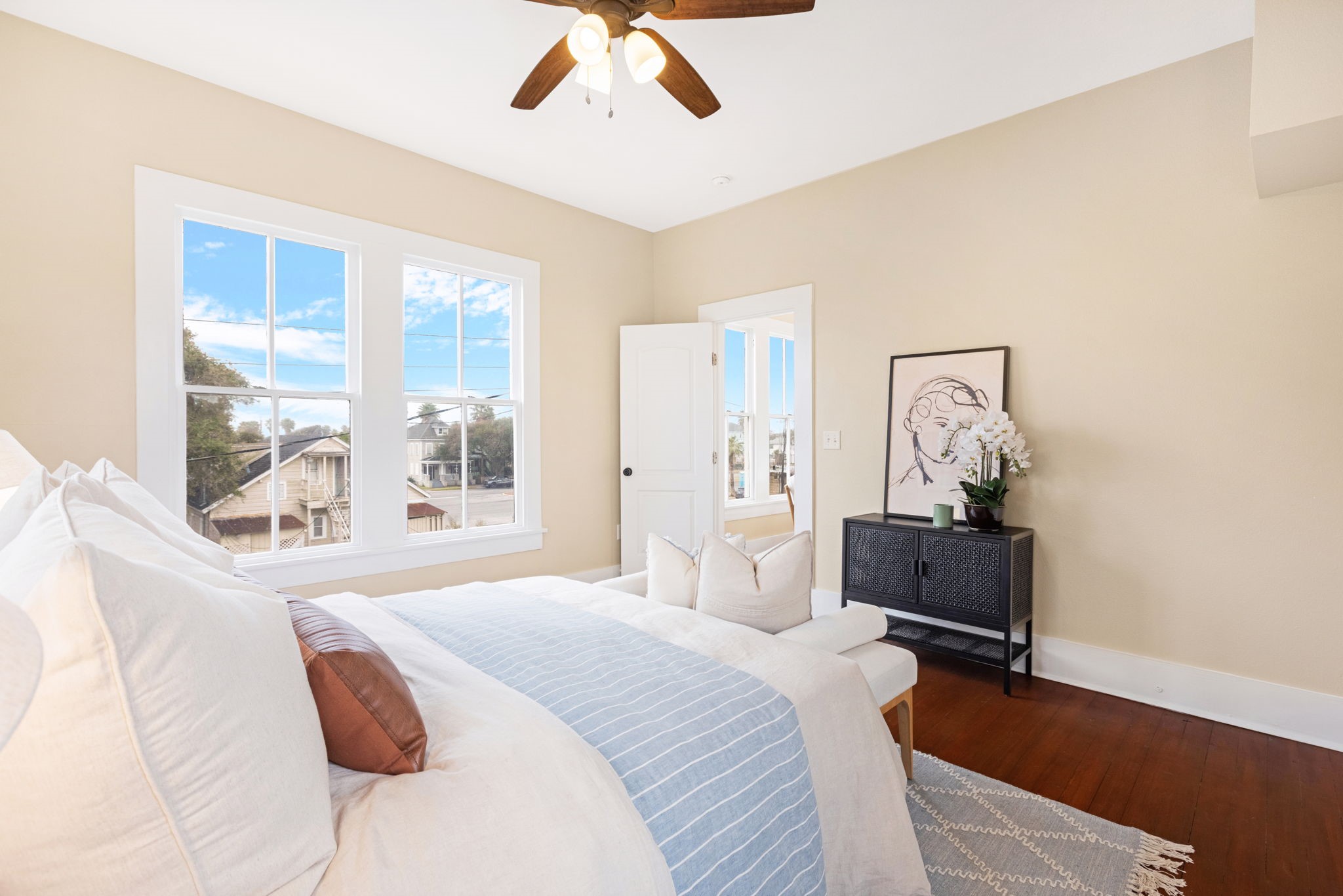 910 9th Street Galveston, TX 77550 - Photo 22 of 49 a bedroom with a bed and wooden floor