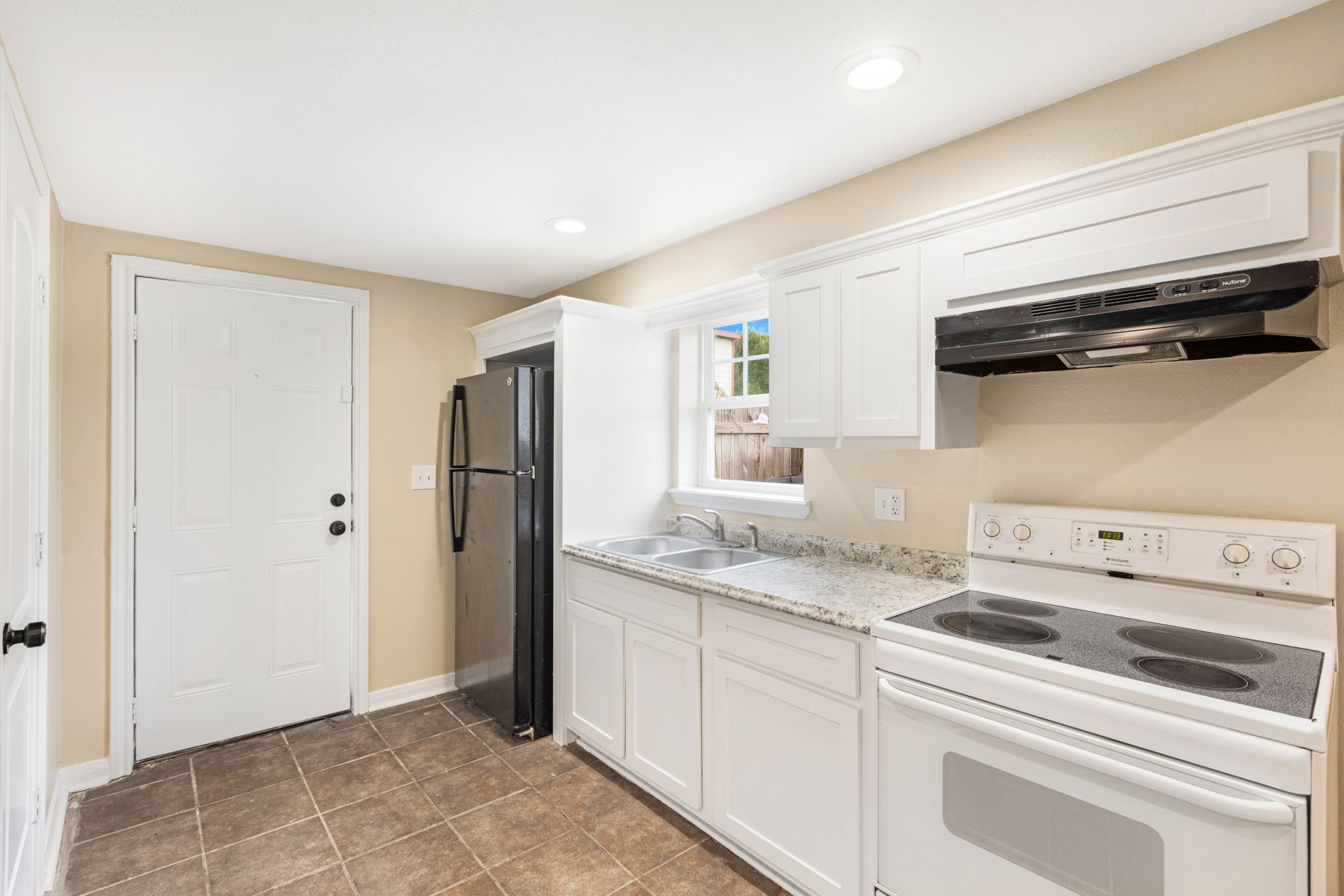 910 9th Street Galveston, TX 77550 - Photo 31 of 49 a kitchen with a refrigerator stove and cabinets