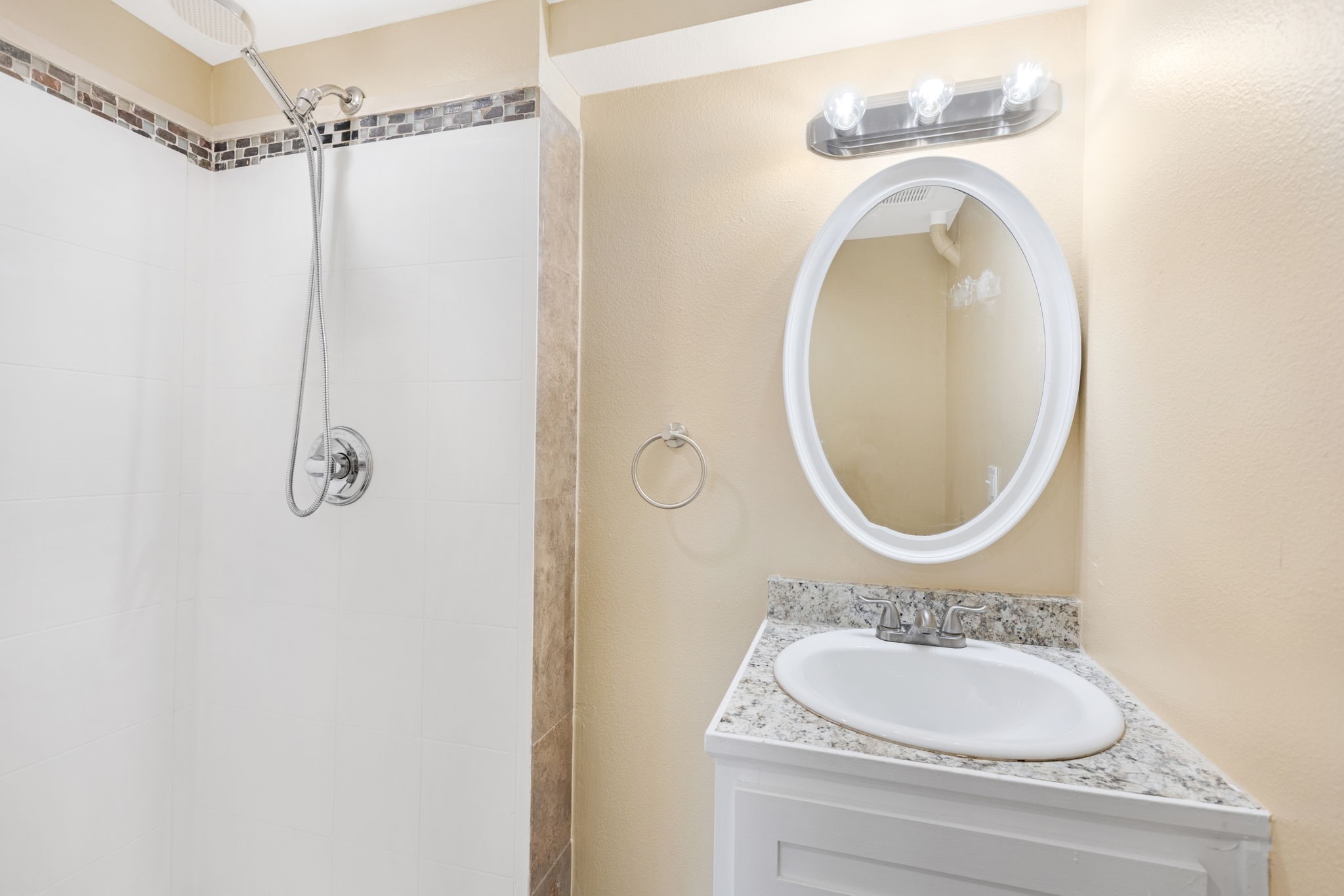 910 9th Street Galveston, TX 77550 - Photo 36 of 49 a bathroom with a sink and a mirror