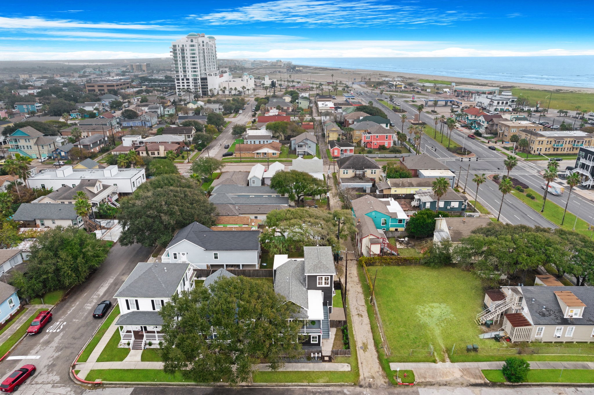 910 9th Street Galveston, TX 77550 - Photo 44 of 49 an aerial view of a city with lots of residential buildings ocean and mountain view in back