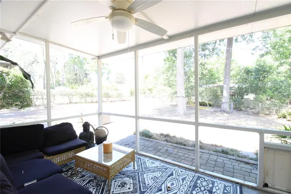 a living room with furniture and a floor to ceiling window