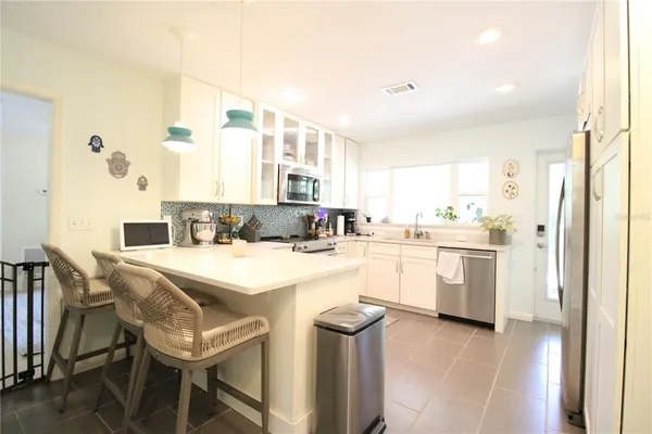 a kitchen with a stove a sink and a refrigerator