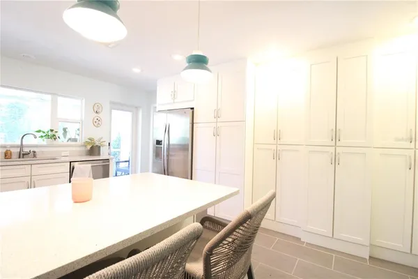 a kitchen with stainless steel appliances refrigerator sink and cabinets