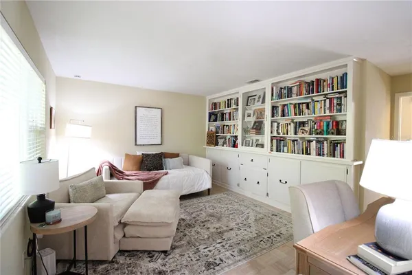 a living room with furniture and a book shelf