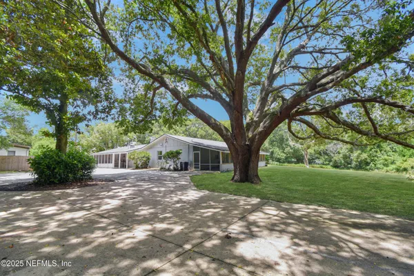 a front view of house with yard and green space