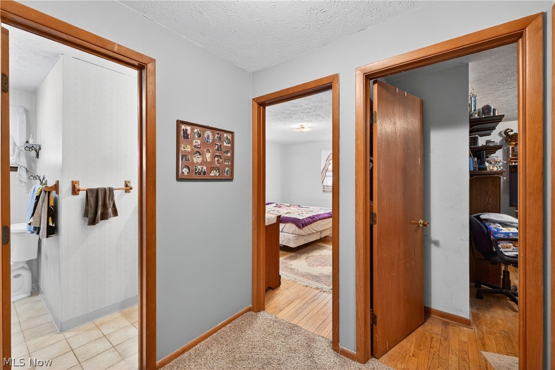 4404 Florida Street Perry, OH 44081 - Photo 10 of 24 Hallway featuring a textured ceiling and baseboards