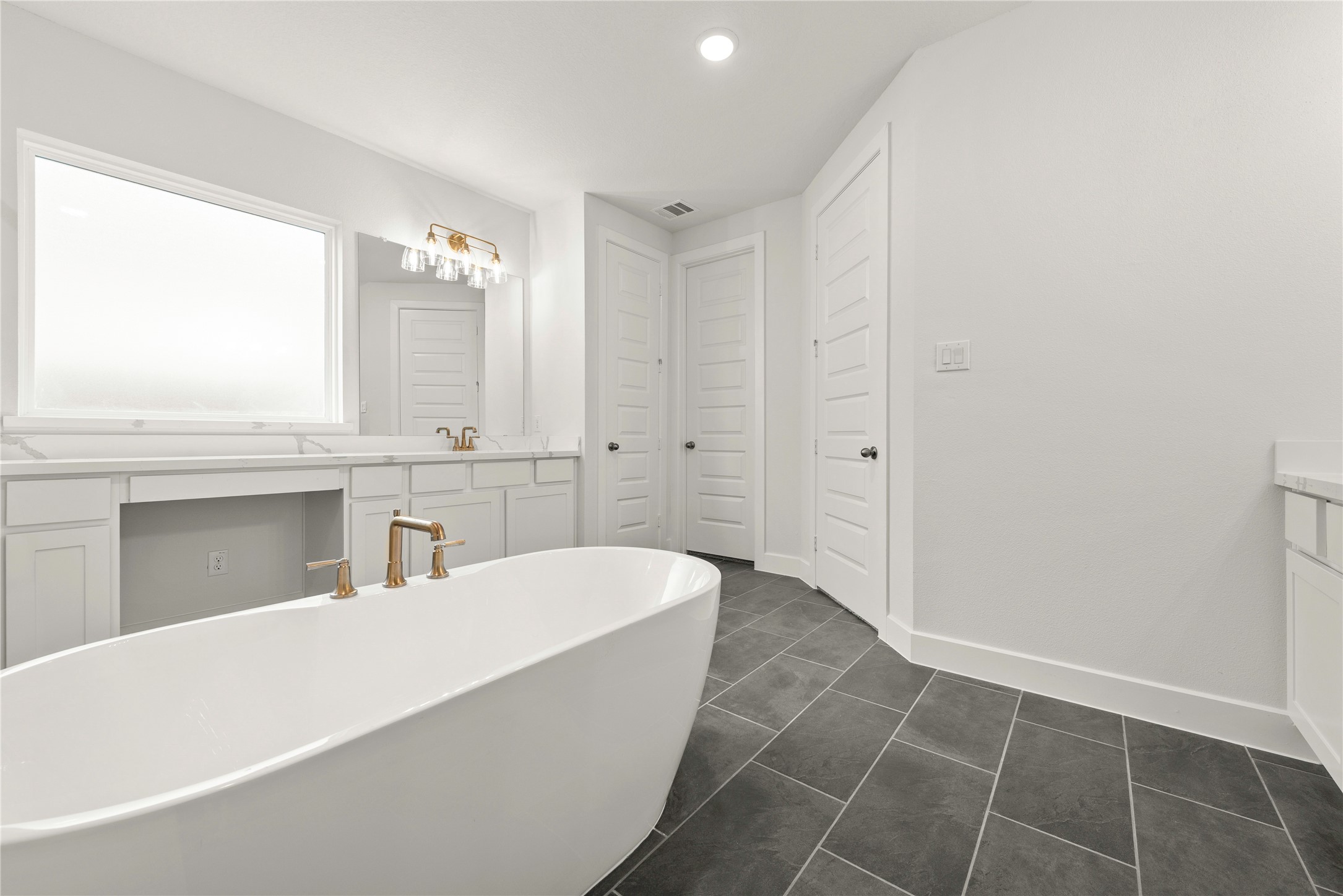 18917 Moonriver Street Conroe, TX 77302 - Photo 10 of 28 a spacious bathroom with a tub shower and sink