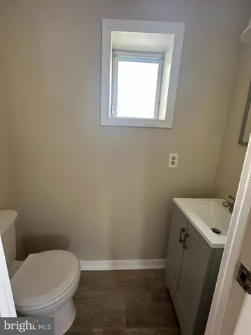 a white toilet sitting in a bathroom next to a window