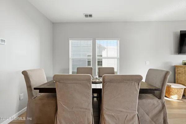 a work room with furniture and a flat screen tv