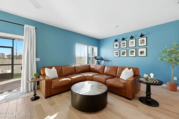 a living room with furniture and wooden floor