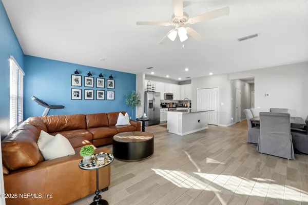 a living room with furniture and kitchen view