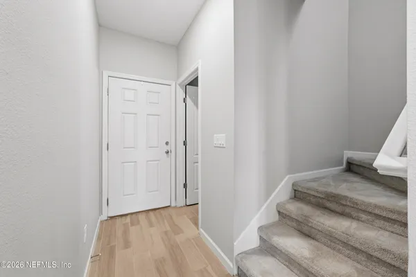 a view of bedroom with wooden floor