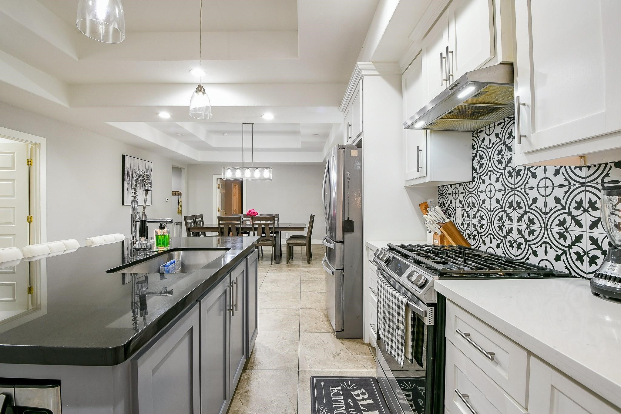 910 11th Street South Houston, TX 77587 - Photo 11 of 32 a kitchen with stainless steel appliances a table chairs and a refrigerator