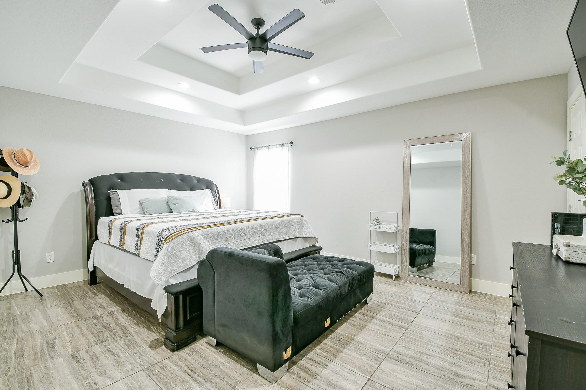 910 11th Street South Houston, TX 77587 - Photo 15 of 32 a bedroom with a large bed and a chandelier