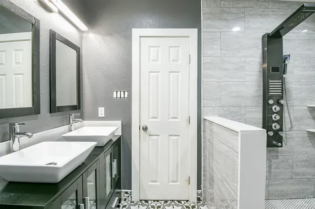 a bathroom with a double vanity sink and a mirror