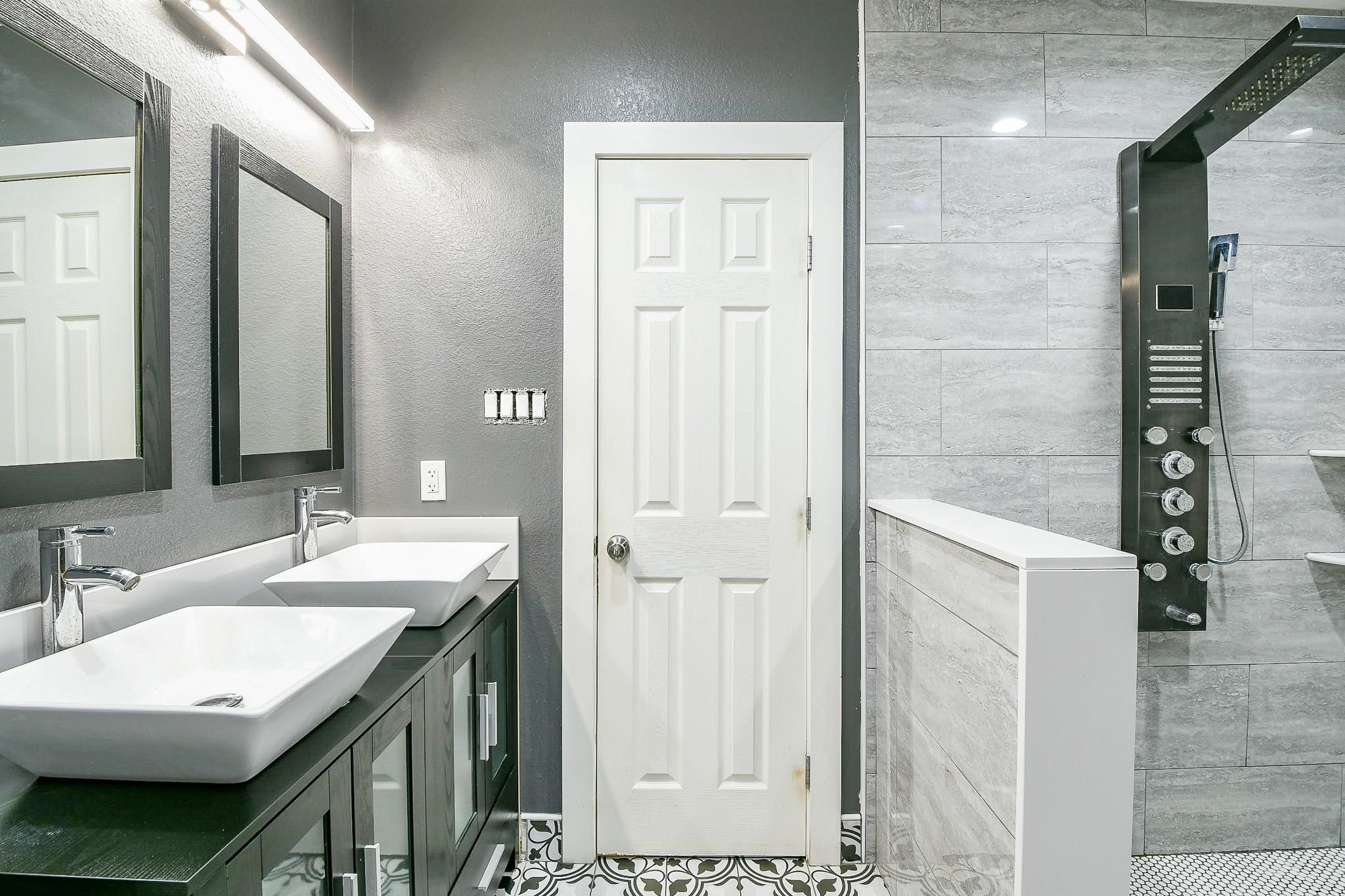 910 11th Street South Houston, TX 77587 - Photo 18 of 32 a bathroom with a double vanity sink and a mirror